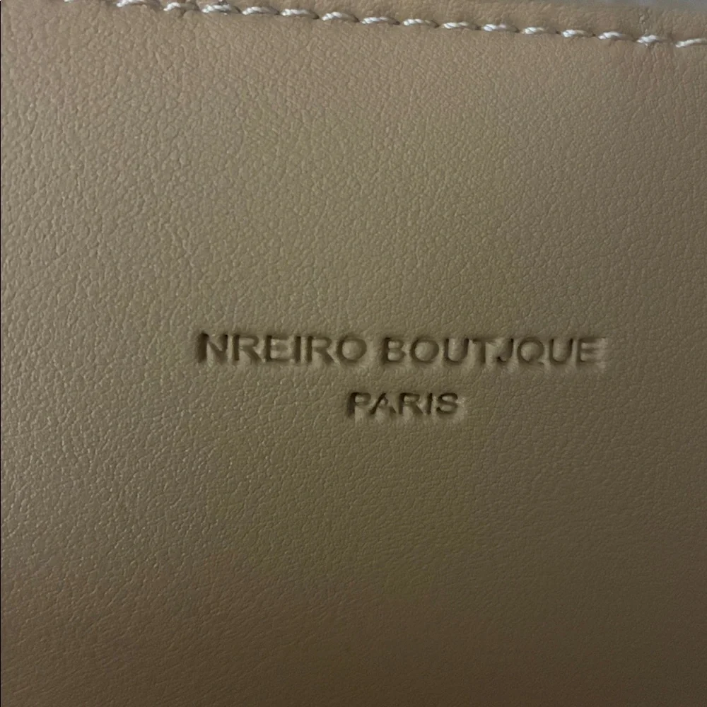 Tan purse‎ with sleek design and smooth finish.